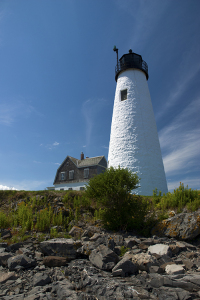 Wood Island lighthouse guides mariner's away from its rocky shores.