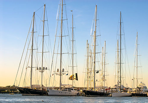 Tall sailing vessels are docked in Newport’s harbor.