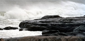 Cold waves crashing on rocks