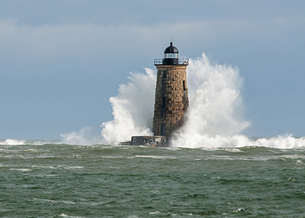 Giant waves cover the stone tower of Whaleback lighthouse in southern Maine during an astronomically high tide.