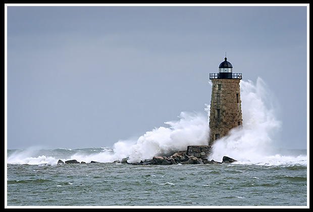 Whaleback lighthouse waves crashing during rare astronomically high tides