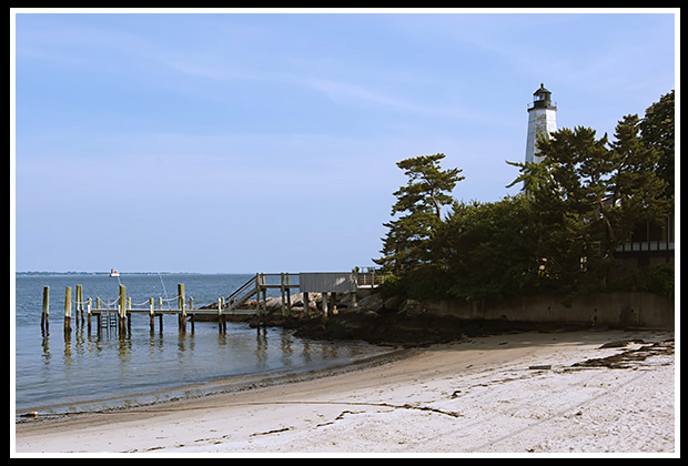 New London Harbor light over beach