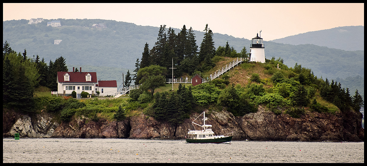 dOwls Head lighthouse above cliffs water view 