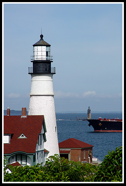 ship starts to pass between Portland Head light and Ram Island Ledge light