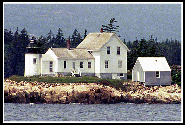 older image distant view of Winter harbor light from road