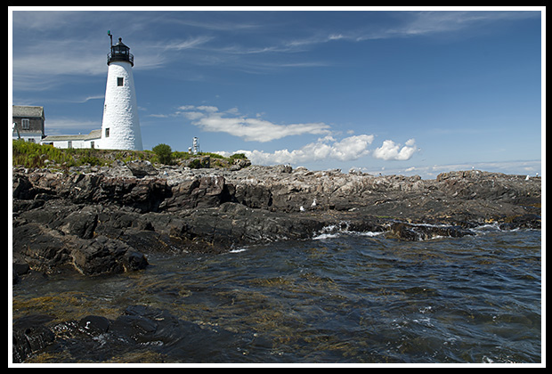 rocky shoreline by Wood Island lighthouse tower
