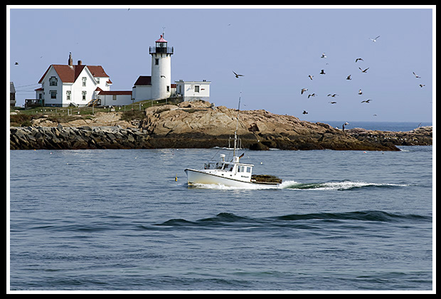 lobsterboat passes by Eastern Point light]