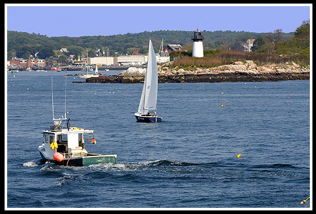 boats sailing past ten pound light