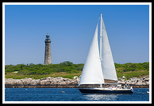 sailboat passes Thacher Island light