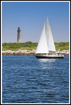 sailboat passes Thacher Island light
