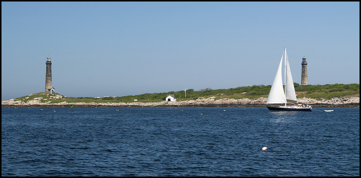sailboat passes between Thacher Island lights