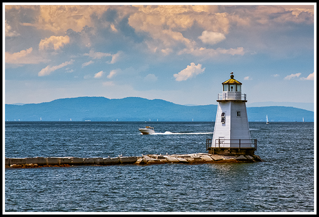 boat passes by Burlington North Light