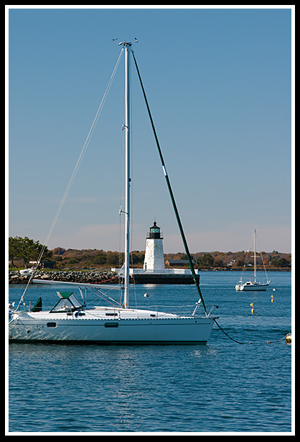 sailboat moored near Newport Harbor light