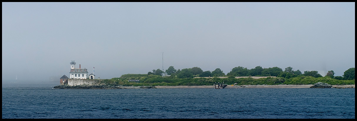 Fog lifts by Rose Island lighthouse