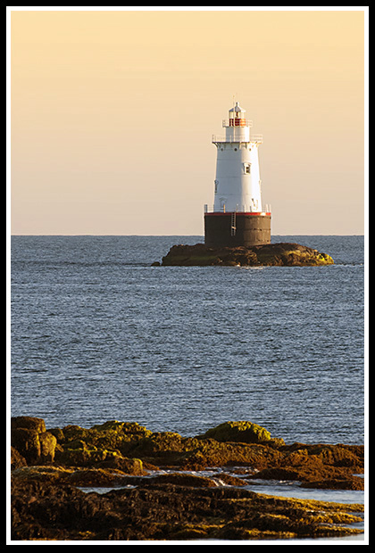 Sakonnet lighthouse tower as sun sets